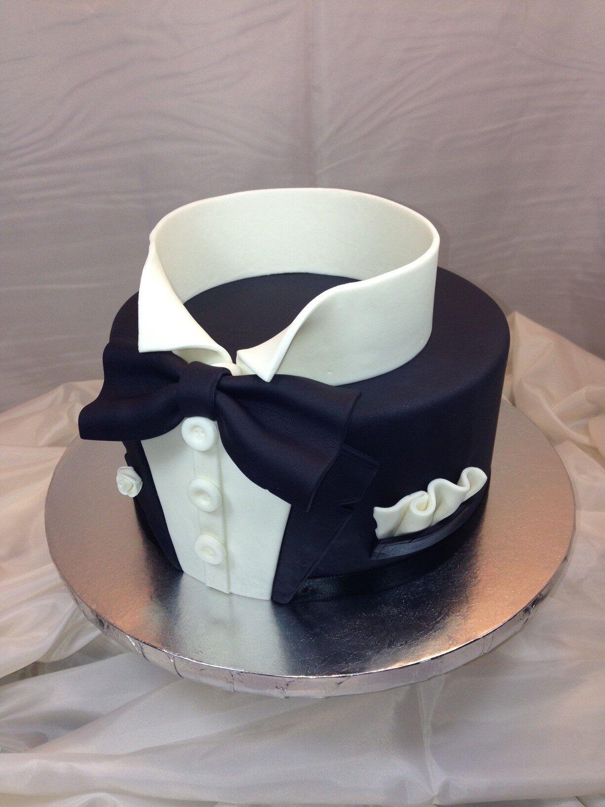Black Tuxedo Cake with Colourful Buttons and Golden Bow